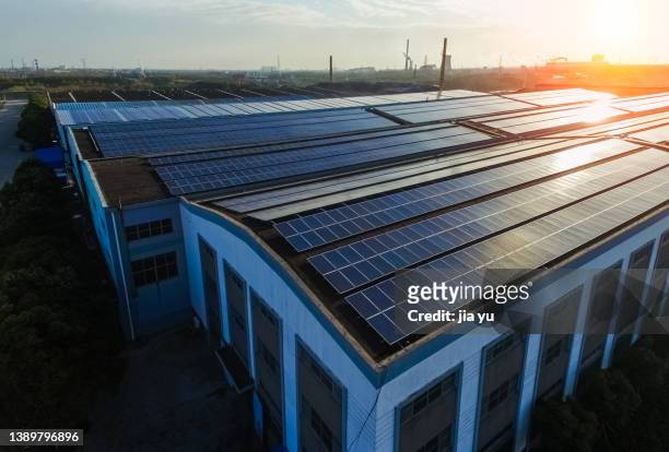 the roof of industrial plant is equipped with solar power station. jiangyin, jiangsu, china. - solar farm stockfoto's en -beelden