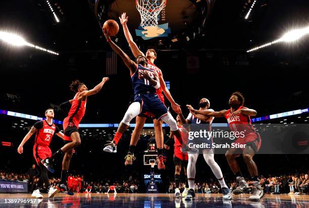 Kyrie Irving of the Brooklyn Nets goes to the basket as Alperen Sengun of the Houston Rockets defends during the game at Barclays Center on April 05,...