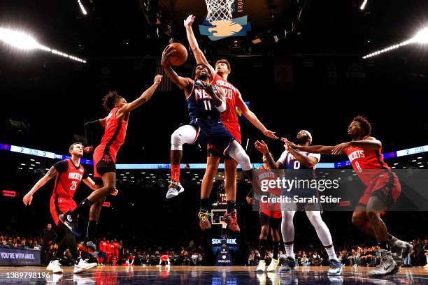 Kyrie Irving of the Brooklyn Nets goes to the basket as Alperen Sengun of the Houston Rockets defends during the game at Barclays Center on April 05,...