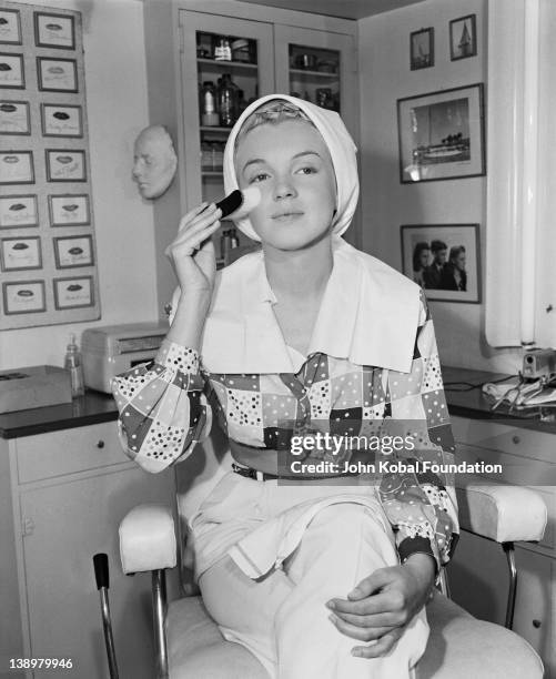 American film star Marilyn Monroe begins the process of applying her make-up, 1948.