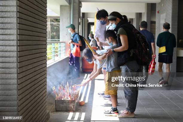 People burn incense sticks to pay tribute to their deceased family members at Diamond Hill Cemetery during Qingming Festival on April 5, 2022 in Hong...