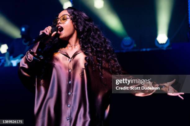 Musician H.E.R. Performs onstage during the 'Back of Your Mind Tour' at YouTube Theater on April 05, 2022 in Inglewood, California.