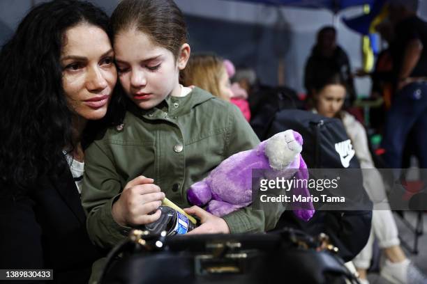 Ukrainian mother and daughter, who are seeking asylum in the U.S., wait to cross the U.S.-Mexico border at the San Ysidro Port of Entry amid the...