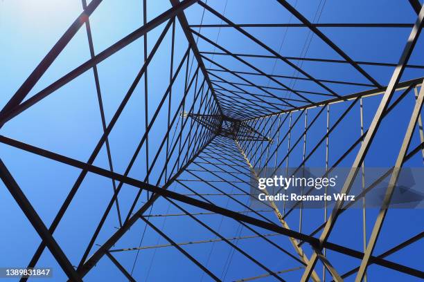 electricity pylon against blue sky - electricity pylon stock-fotos und bilder