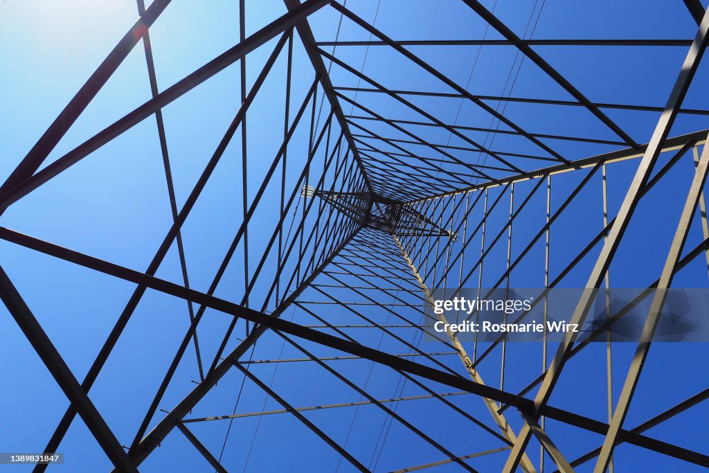 Electricity pylon against blue sky