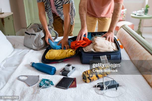 gay couple packing their suitcase - suitcase couple stock pictures, royalty-free photos & images