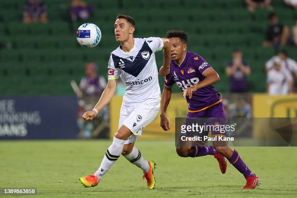 Chris Ikonomidis of the Victory controls the ball against Antonee Burke-Gilroy of the Glory during the A-League Mens match between Perth Glory and...