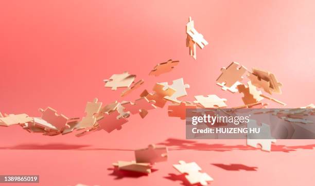 flying puzzle pieces. creative concept - puzzle stock-fotos und bilder