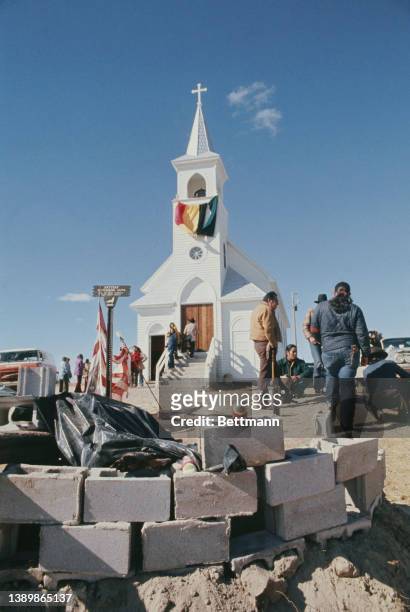 The Sacred Heart Church, overlooking the site of the 1890 Wounded Knee Massacre, during the Wounded Knee Occupation , note the American flag flying...