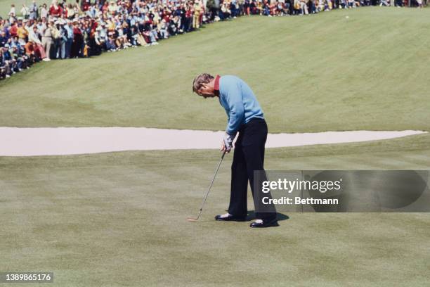 American golfer Arnold Palmer taking a putt on an green during the 1973 Masters Tournament, held at the Augusta National Golf Club in Augusta,...