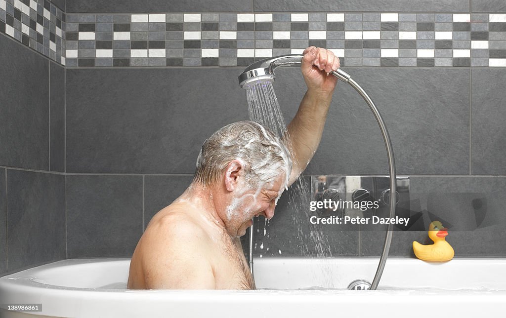 Active senior washing in bath