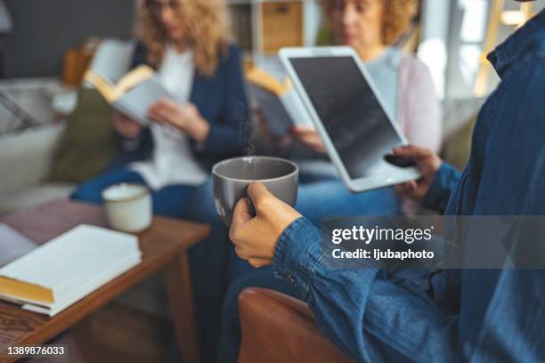 diverse group of friends in library. - online library stock pictures, royalty-free photos & images