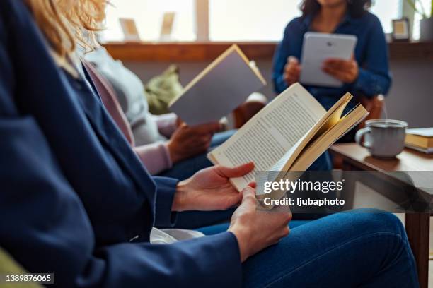 the library is their favourite place to learn - book club meeting stock pictures, royalty-free photos & images