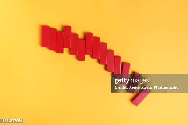 market data bar chart made of red wooden toy blocks on yellow - line graph down stock pictures, royalty-free photos & images