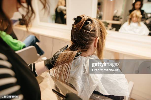 close-up of a hairdresser dying a female hair - beauty salon stock pictures, royalty-free photos & images