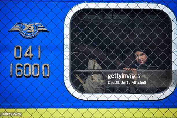 Child looks out of a train window as people, mainly women and children, pass through Przemysl train station after journeying from war-torn Ukraine on...