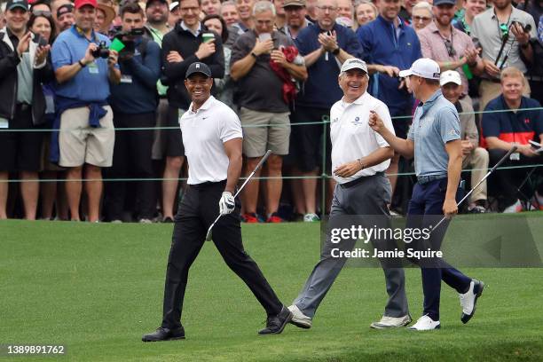Tiger Woods of the United States, Fred Couples of the United States and Justin Thomas of the United States walk on the 16th hole during a practice...