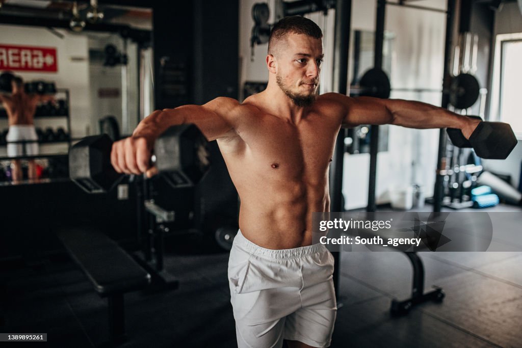 Man Straining As He Rows Man Training With Dumbbells High-Res Stock Photo - Getty Images