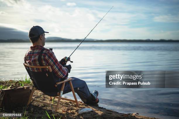 fishing in the lake - fisherman stock-fotos und bilder