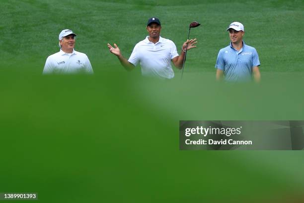 Fred Couples of the United States, Tiger Woods of the United States and Justin Thomas of the United States walk on the 17th hole during a practice...