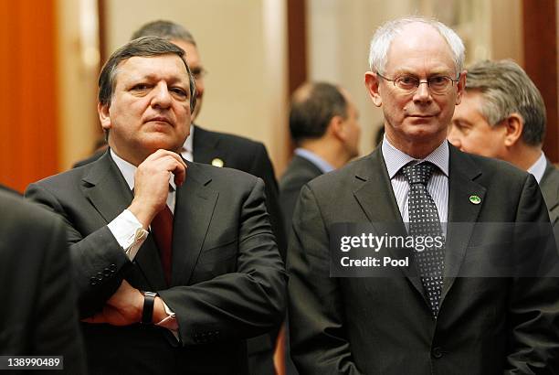 European Commission President Jose Manuel Barroso and European Council President Herman Van Rompuy wait in a corridor for their meeting with Chinese...