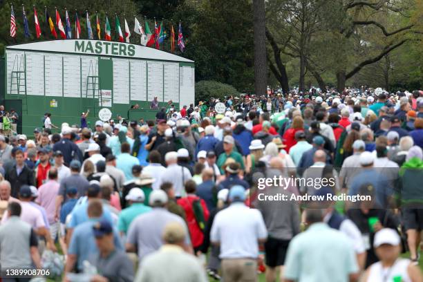 Patrons exit the course during a delay dur to inclement weather during a practice round prior to the Masters at Augusta National Golf Club on April...