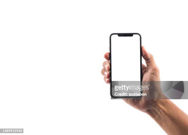 close up of man hand holding smartphone on white background, cropped hand using smartphone on the background white - stock photo - laptop fotografías e imágenes de stock