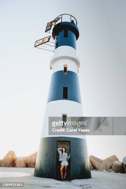 one tourist standing in front of  aveiro lighthouse,portugal - アヴェイロ県 ストックフォトと画像