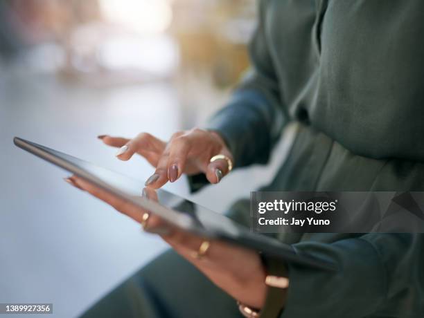 shot of a businesswoman using a digital tablet in a modern office - jay space stock pictures, royalty-free photos & images