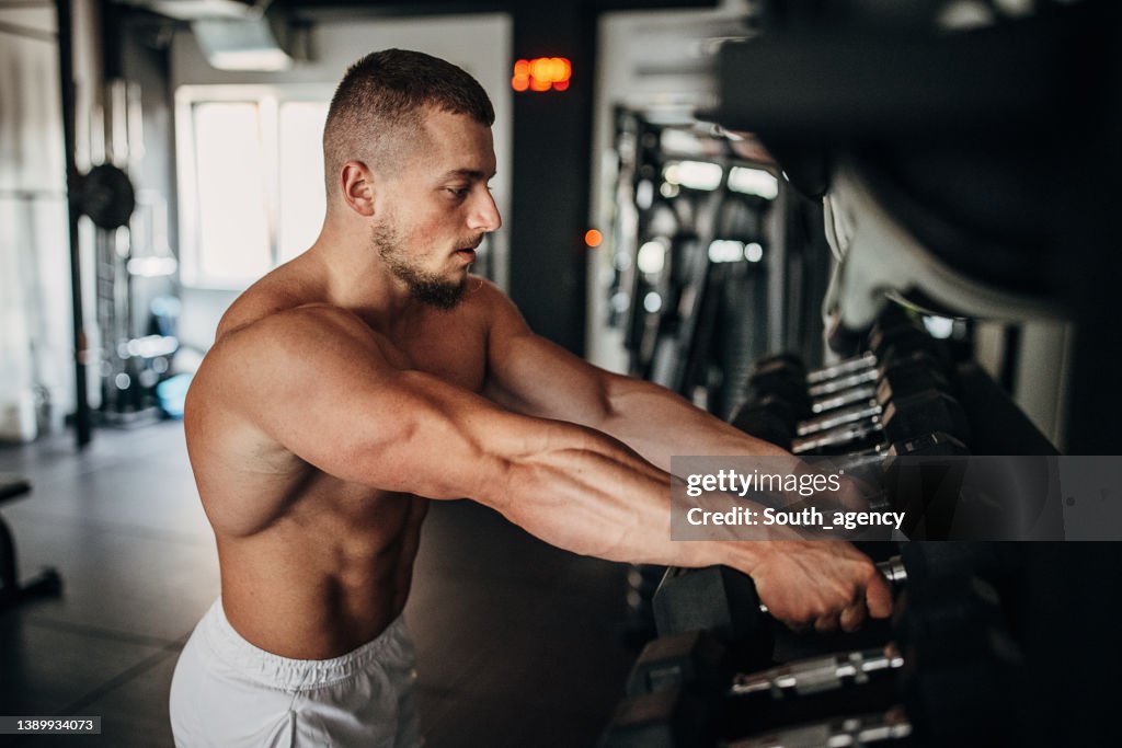Man taking dumbbells for training