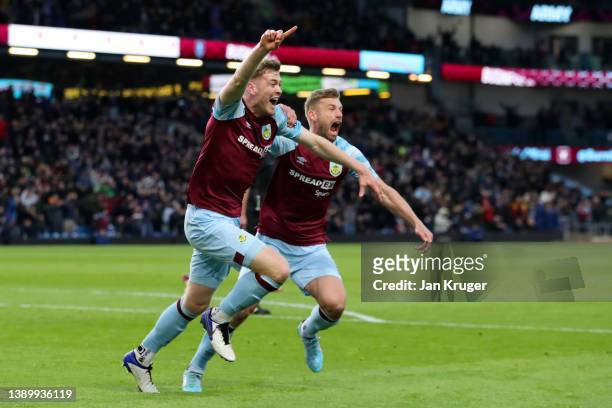 Nathan Collins of Burnley celebrates with teammate Charlie Taylor after scoring their team's first goal during the Premier League match between...