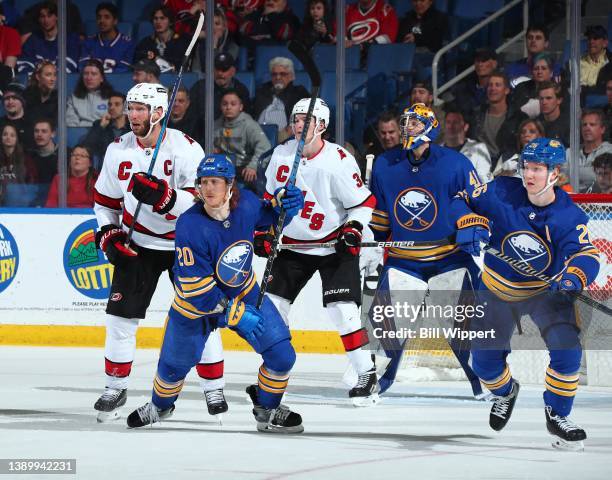 Cody Eakin and Rasmus Dahlin of the Buffalo Sabres skate against Jordan Staal of the Carolina Hurricanes during an NHL game on April 5, 2022 at...