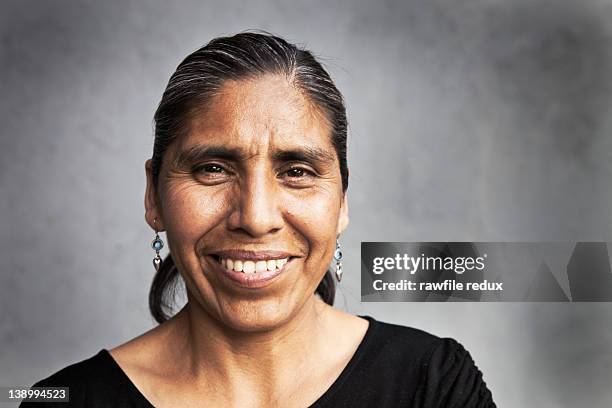 portrait of a middle aged mexican woman smiling. - mexican mature women stock pictures, royalty-free photos & images