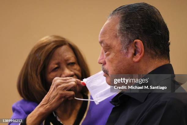 Dr. Hazel N. Dukes, president of the NAACP New York State Conference and a member of the NAACP National Board of Directors, helps to put a mask on...