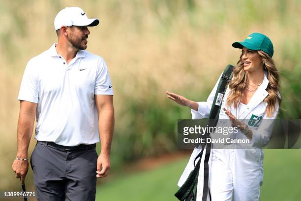 Brooks Koepka of the United States and Jena Sims during the Par Three Contest prior to the Masters at Augusta National Golf Club on April 06, 2022 in...