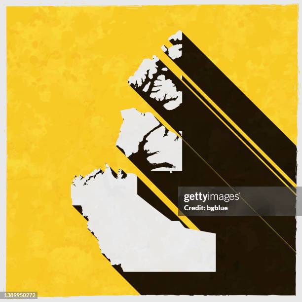 northwest territories map with long shadow on textured yellow background - yellowknife stock illustrations