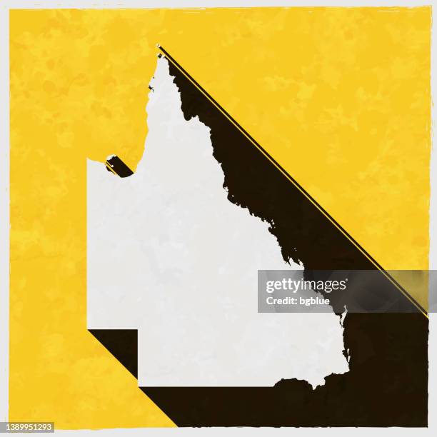 queensland map with long shadow on textured yellow background - brisbane sign stock illustrations