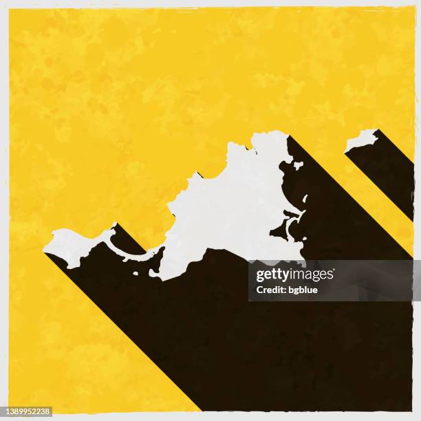 saint-martin map with long shadow on textured yellow background - marigot stock illustrations