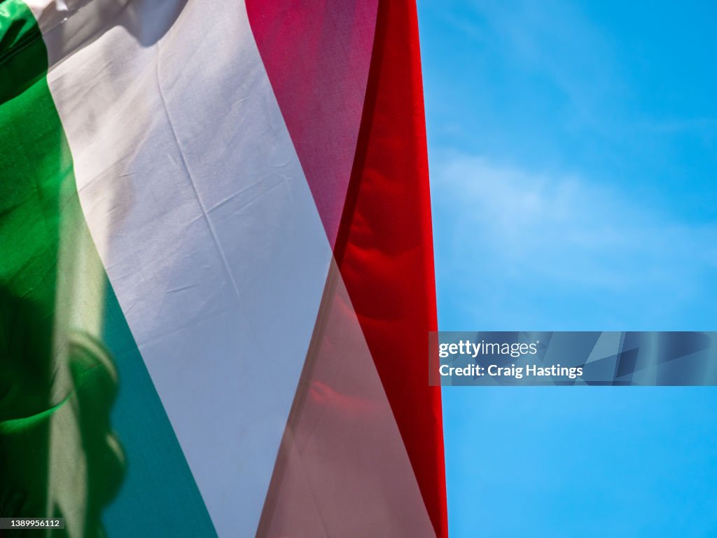 Close up Shot of Italian Flag outside government embassy style building. Concept piece for Italy diplomacy, co-operation, sovereignty, conflict and international relations. Almost full screen but with Copy space available