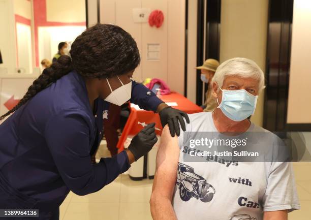 Registered nurse Barbara Dorsima administers a COVID-19 booster vaccination to Mike Bagley at a COVID-19 vaccination clinic on April 06, 2022 in San...