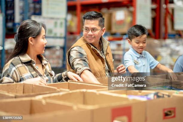 packing at a local food bank - animal related occupation stock pictures, royalty-free photos & images