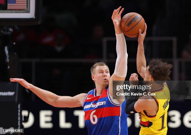 Kristaps Porzingis of the Washington Wizards blocks a pass by Trae Young of the Atlanta Hawks during the first half at State Farm Arena on April 06,...