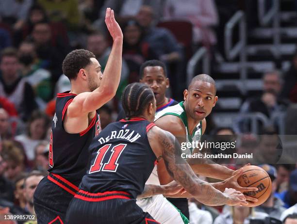 Al Horford of the Boston Celtics is pressured by DeMar DeRozan and Zach LaVine of the Chicago Bulls as he looks to pass at the United Center on April...