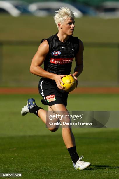Jack Ginnivan of the Magpies runs with the ball during a Collingwood Magpies AFL training session at Olympic Park on April 07, 2022 in Melbourne,...