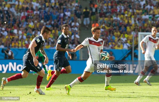 Mario Goetze of Germany and Lois Remy of France during World Cup Quarter Final match between Germany and France at the Maracana- Estadio Journalist...