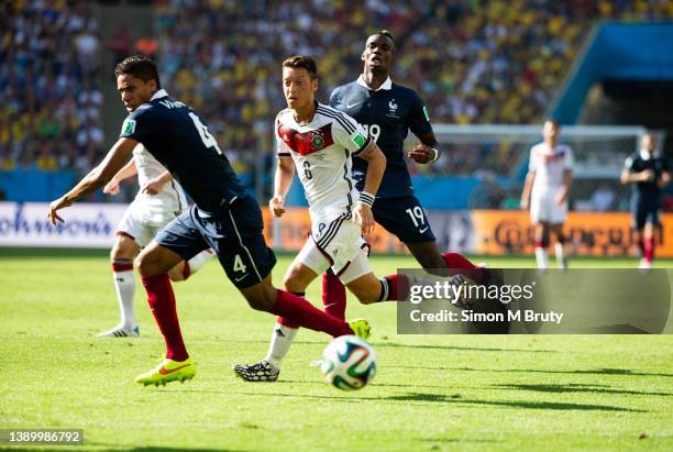 Mesut Ozezil of Germany, Paul Pogba and Raphael Varane of France during World Cup Quarter Final match between Germany and France at the Maracana-...