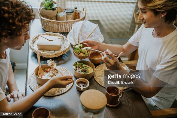 healthy eating of asian gay couple. - packaging of food stockfoto's en -beelden