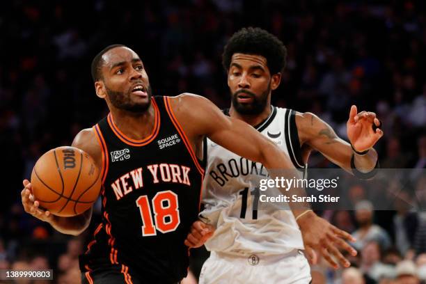 Alec Burks of the New York Knicks dribbles as Kyrie Irving of the Brooklyn Nets defends during the second half at Madison Square Garden on April 06,...