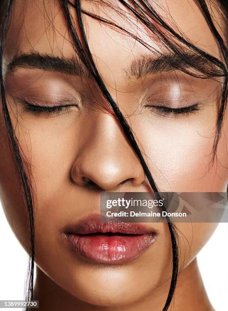 studio shot of an attractive young woman posing against white background - face eyes closed stock pictures, royalty-free photos & images