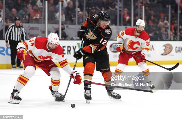 Sonny Milano of the Anaheim Ducks splits the defense of Erik Gudbranson and Dillon Dube of the Calgary Flames during the first period of a game at...